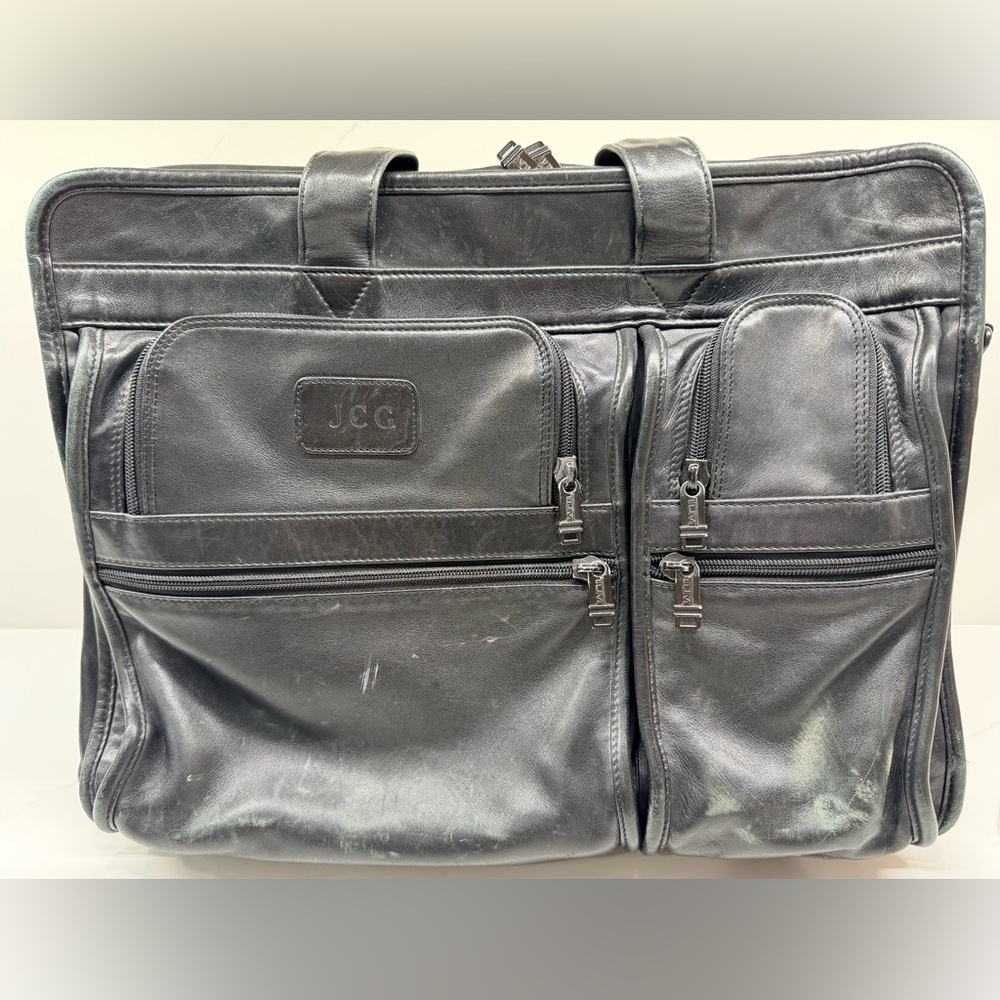 Tumi expandable, black leather briefcase